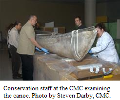 Conservation staff at the CMC examining the canoe. Photo by Steven Darby, CMC